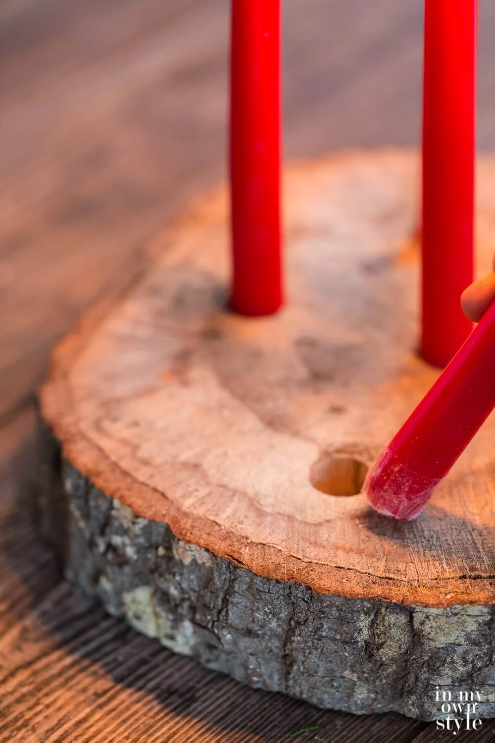 How to place a candle in a drilled hole to create a tree trunk candle holder.