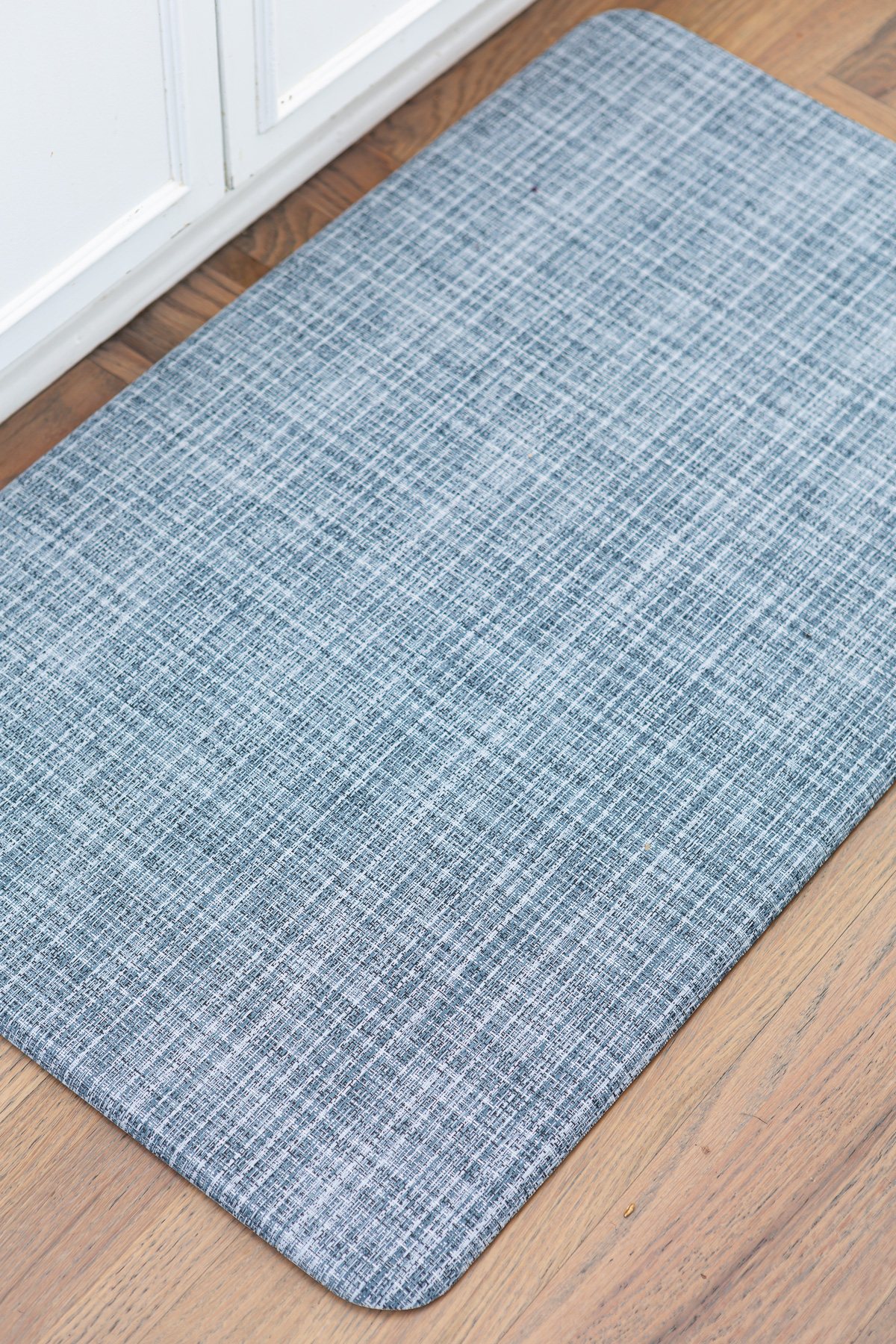 close up of blue Lucky Brand anti-fatigue wellness mat in kitchen.