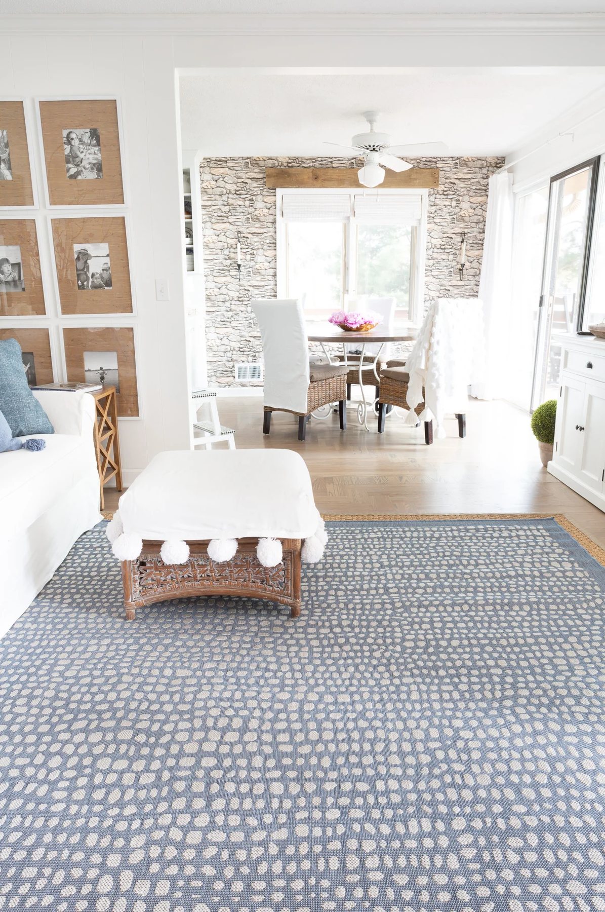 blue and white rug in a living room looking into a dining room.