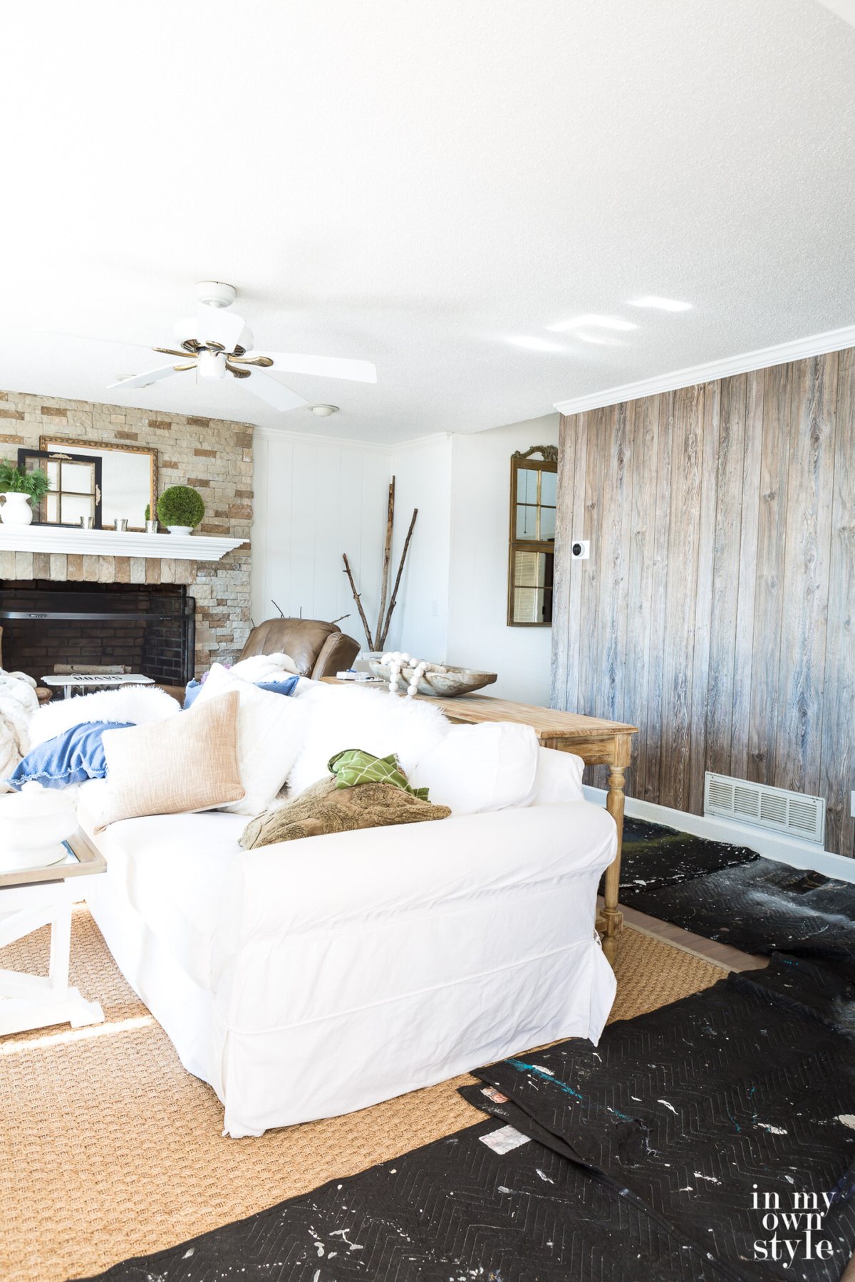 Stone fireplace and barnwood paneled accent wall