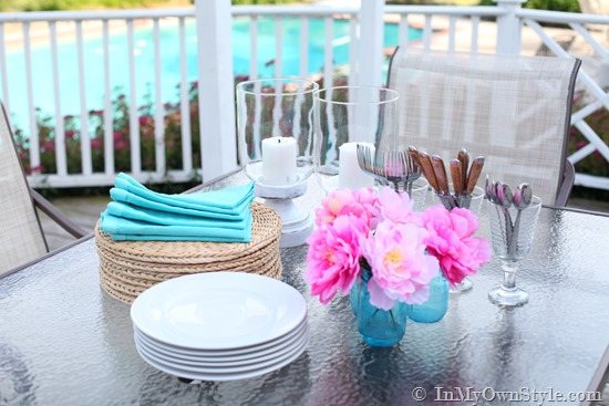 Thrift store candle vases painted white to use on outdoor table