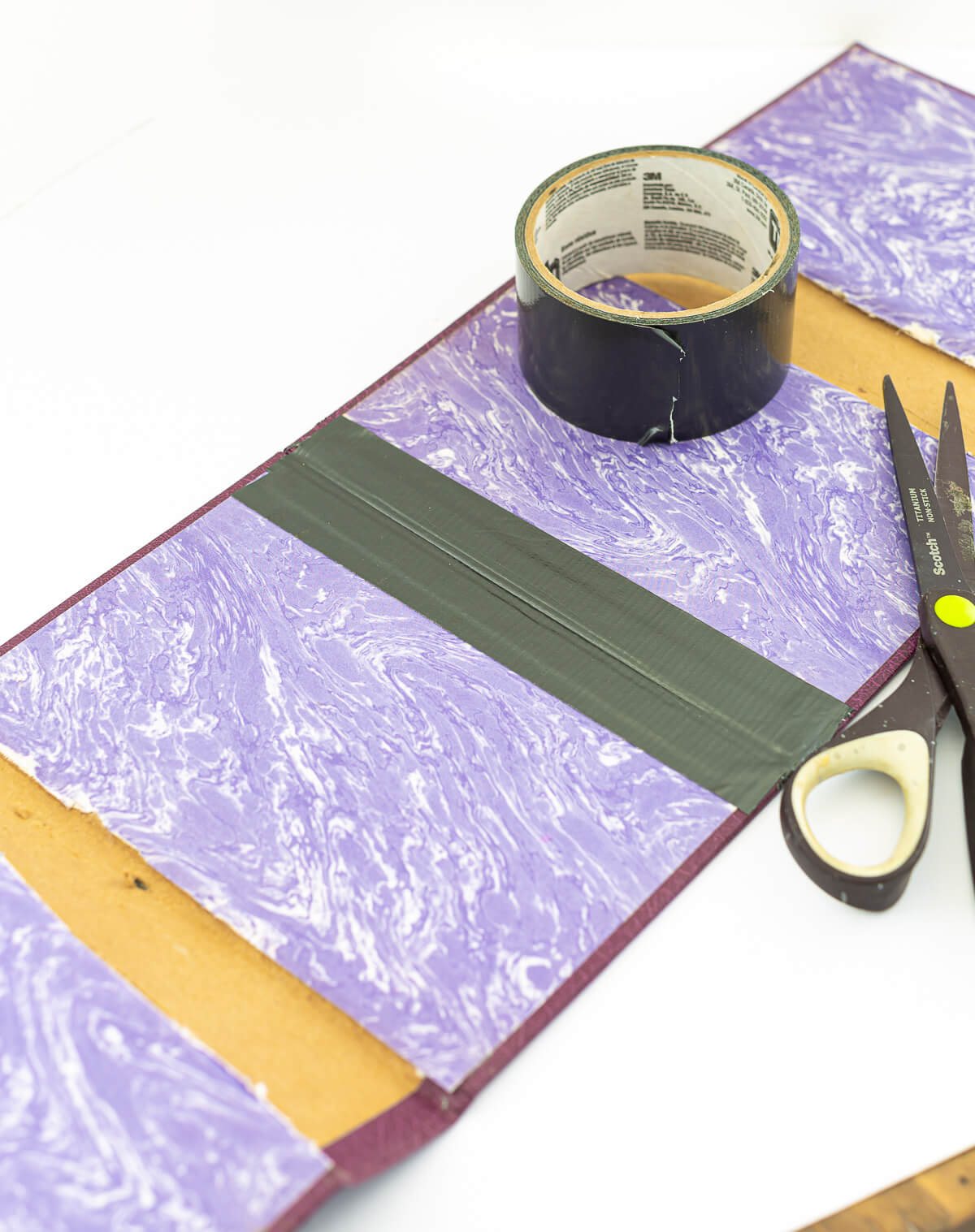 DIY Crafts With Old Books to make a colorful way to hide an ugly flower pot.