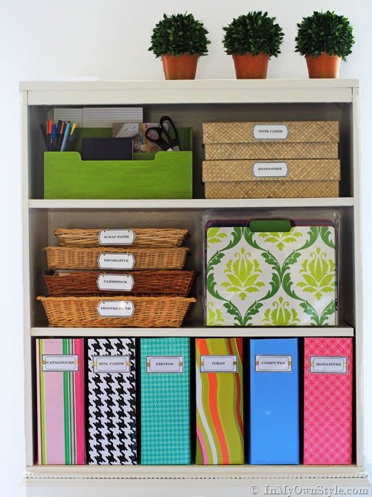 white bookcase with colorful labeled file boxes and baskets