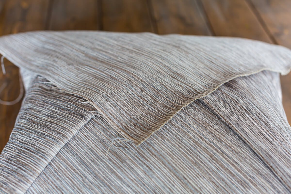 How to fold fabric over a pillow insert to make a decorative pillow.