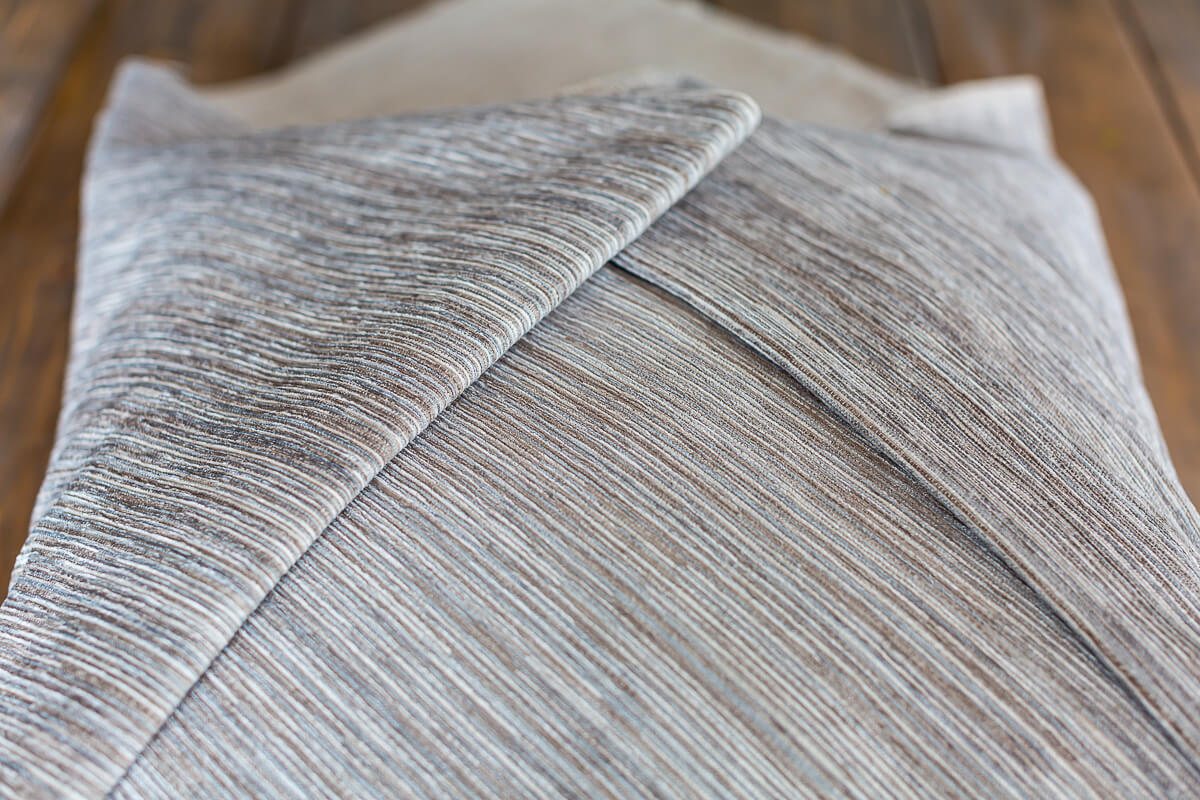 Folded edges of fabric on no sew envelope pillow.
