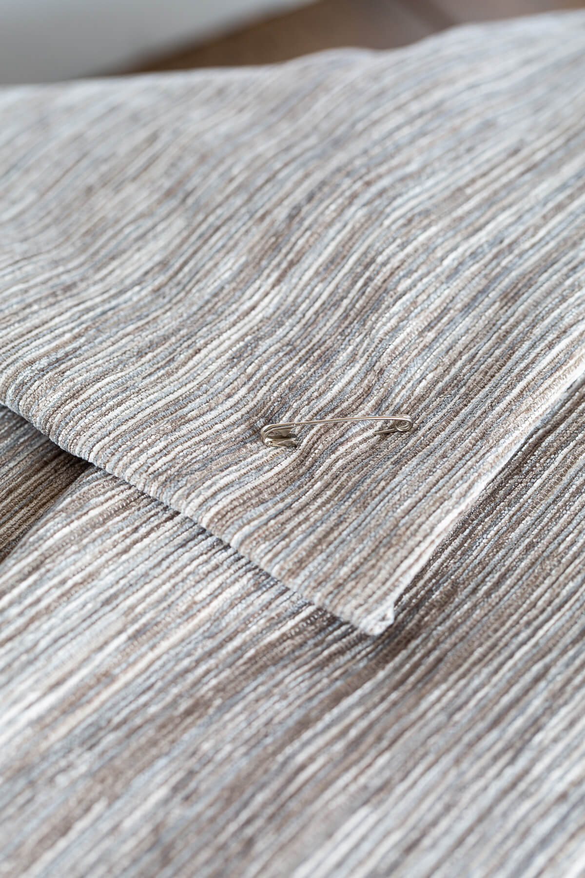 close up of safety pin closure on pillow