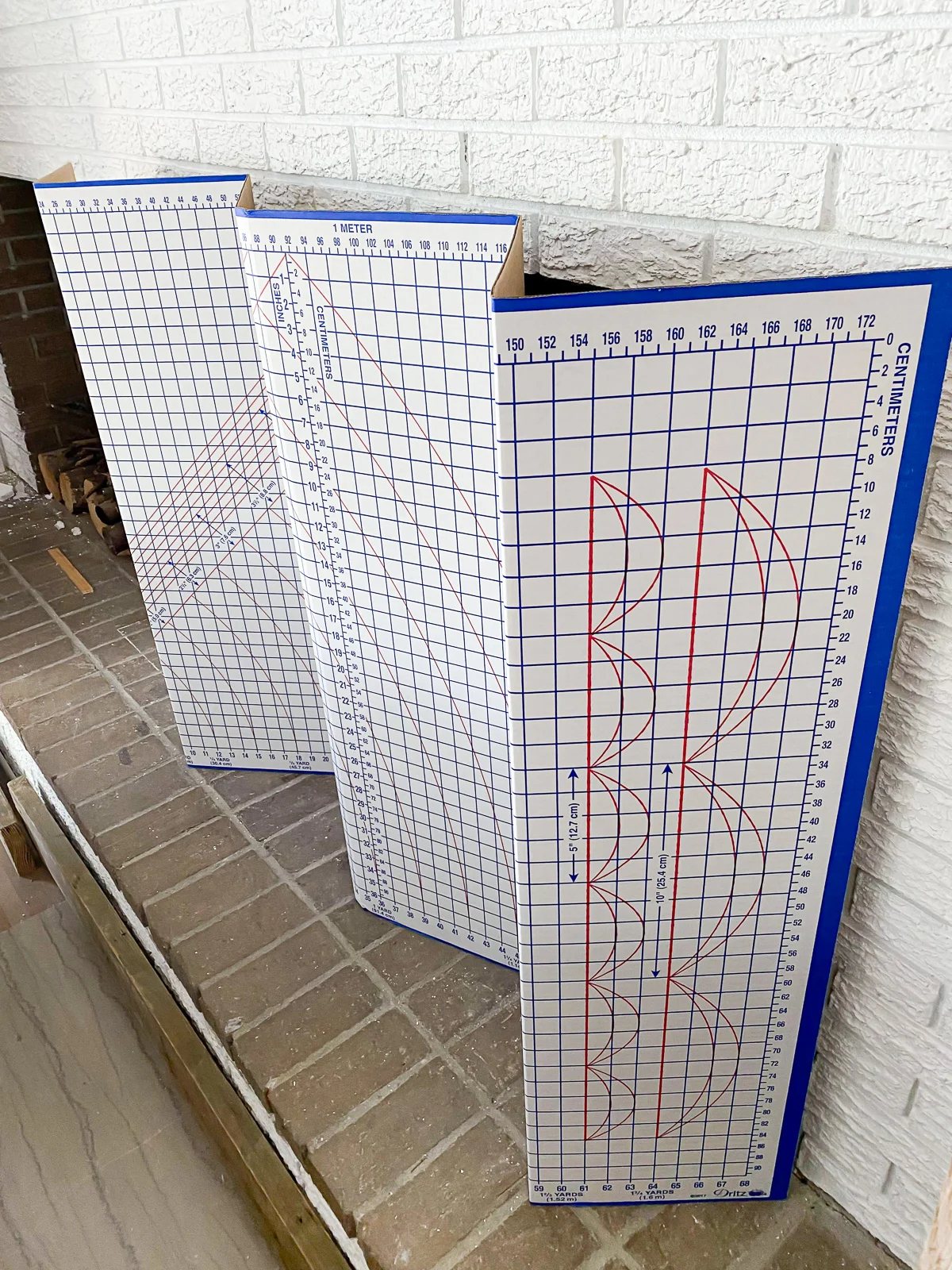 Easy DIY fireplace screen for summer can be made using a cardboard pattern cutting board.