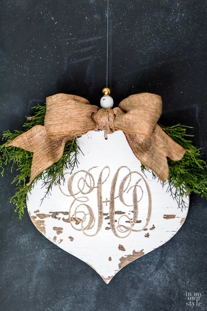 carved-monogram-into-a-rustic-wood-christmas-ornament