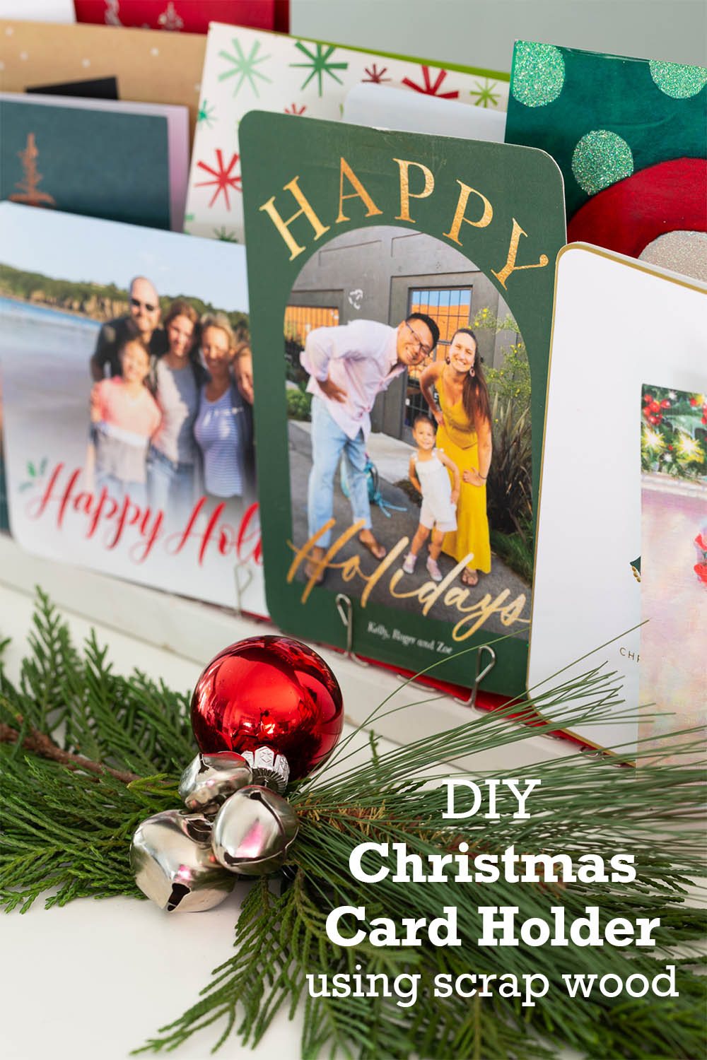 Close up photo of Christmas cards on holder. Text overlay says DIY Christmas Card holder using scrap wood.
