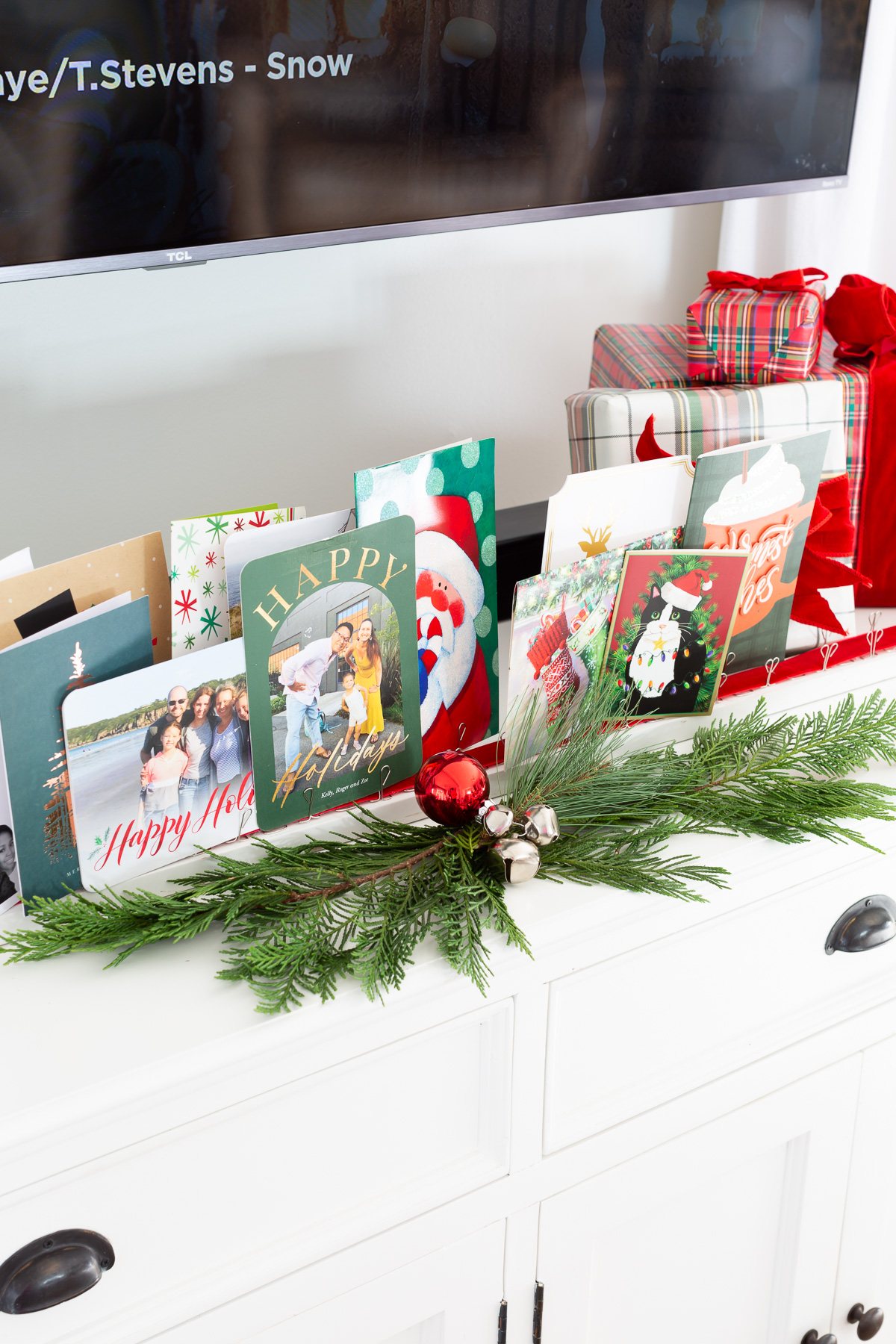Christmas cards displayed on a DIY wood holder on a table top.