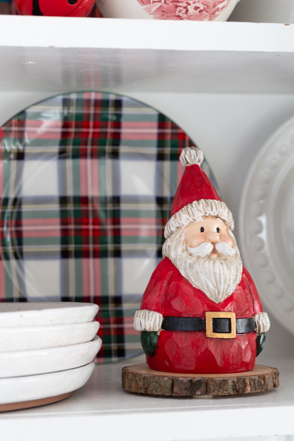 Wooden Santa in red on shelf in kitchen.