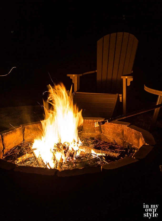 Outdoor fire pit ready to use marshmallow roasting sticks to make S'Mores