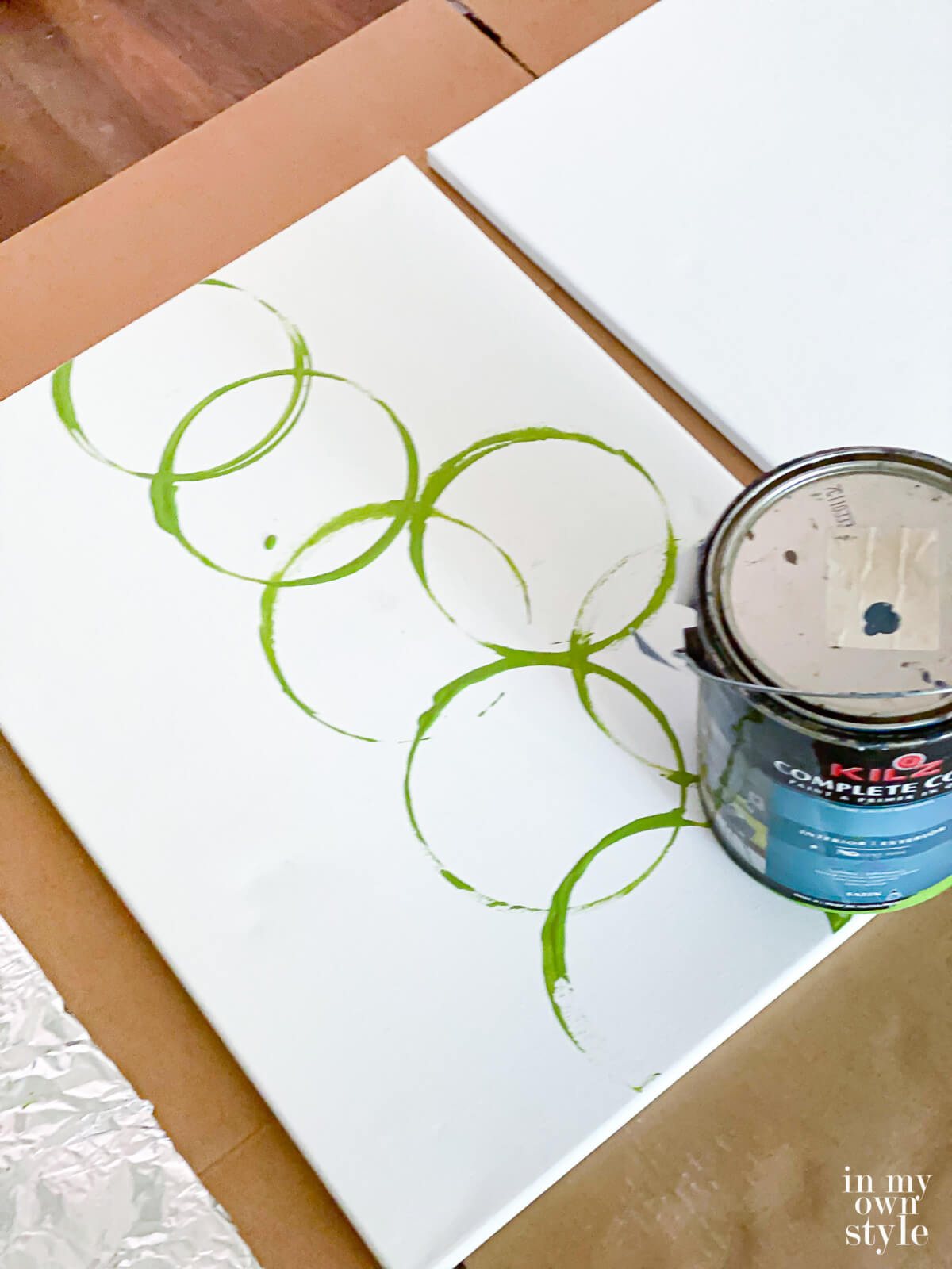 How to make modern art on canvas using the bottom of a gallon paint can.