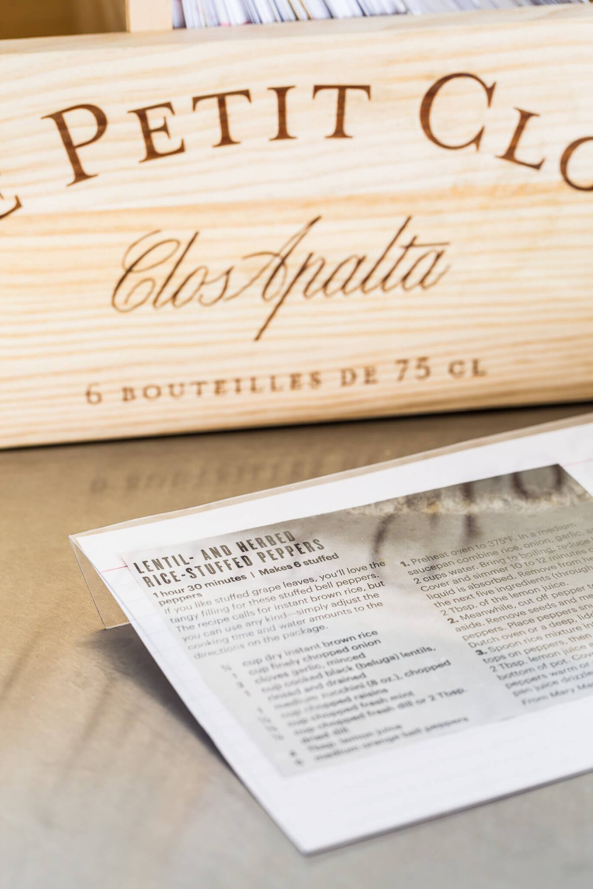 DIY clear cover for recipe cards so they don't get splattered when cooking or baking. Wood wine crate in background.