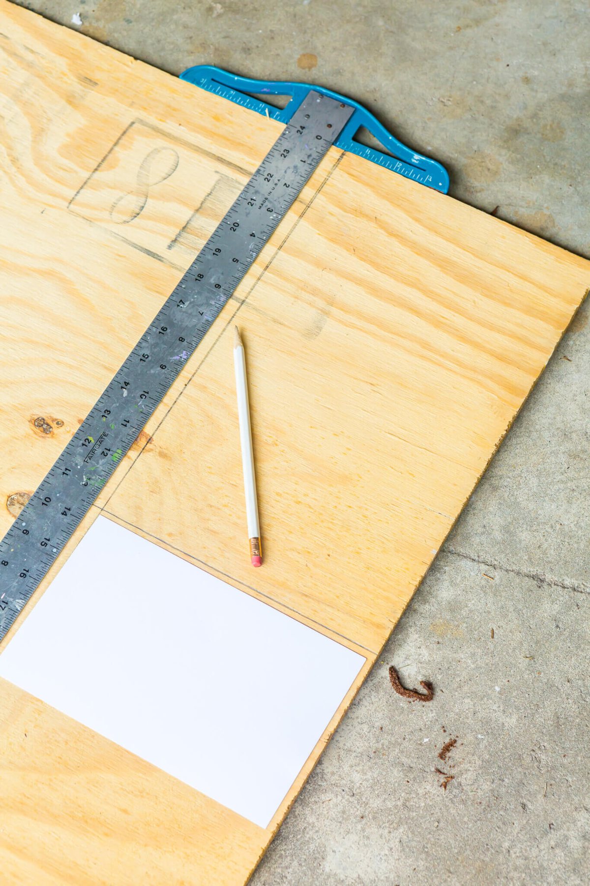 Measuring plywood for bottom on recipe box.