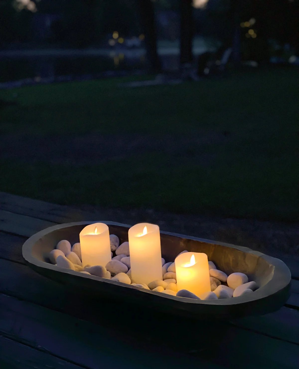 dough bowl filled with rocks and battery operated candles makes an instant tabletop fire bowl.