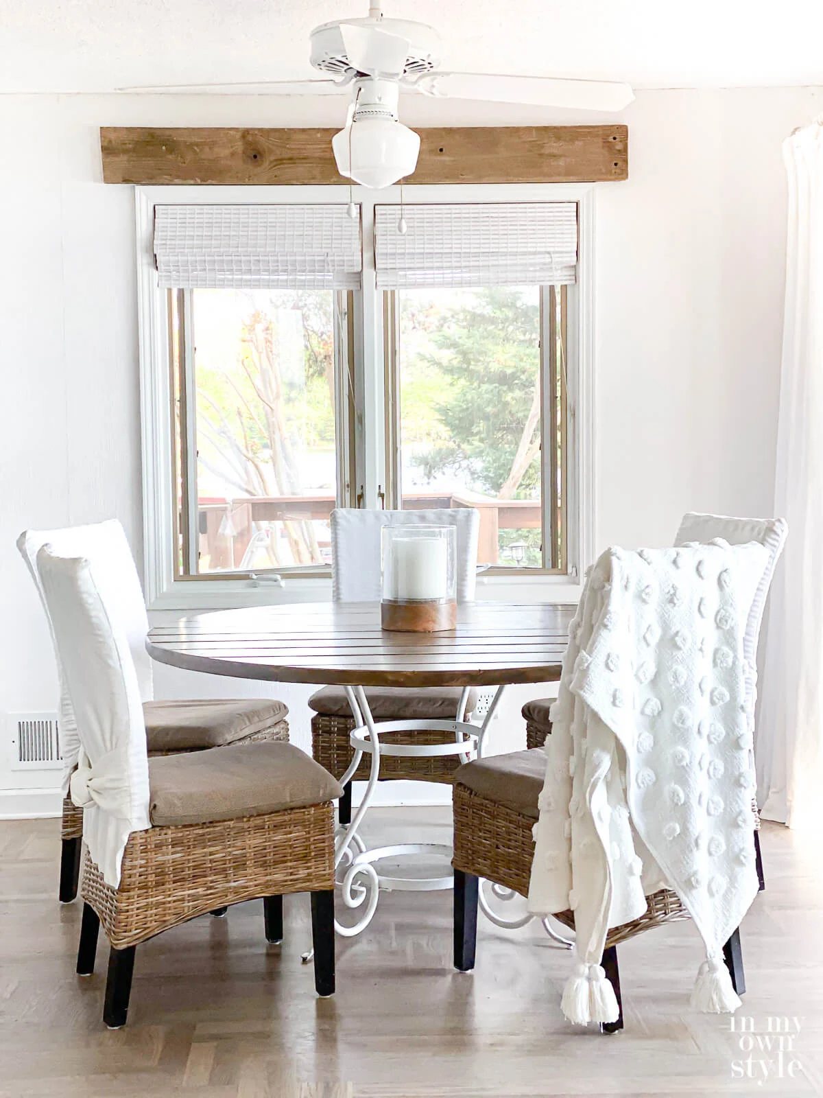 Newly made DIY pine wood board round table on white metal table base.