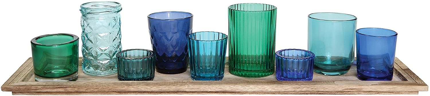 blue and turquoise glass votives on a wood tray