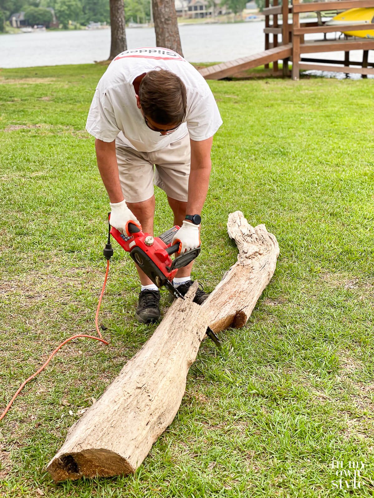 Cutting a driftwood log to size to make diy home decor out of it.
