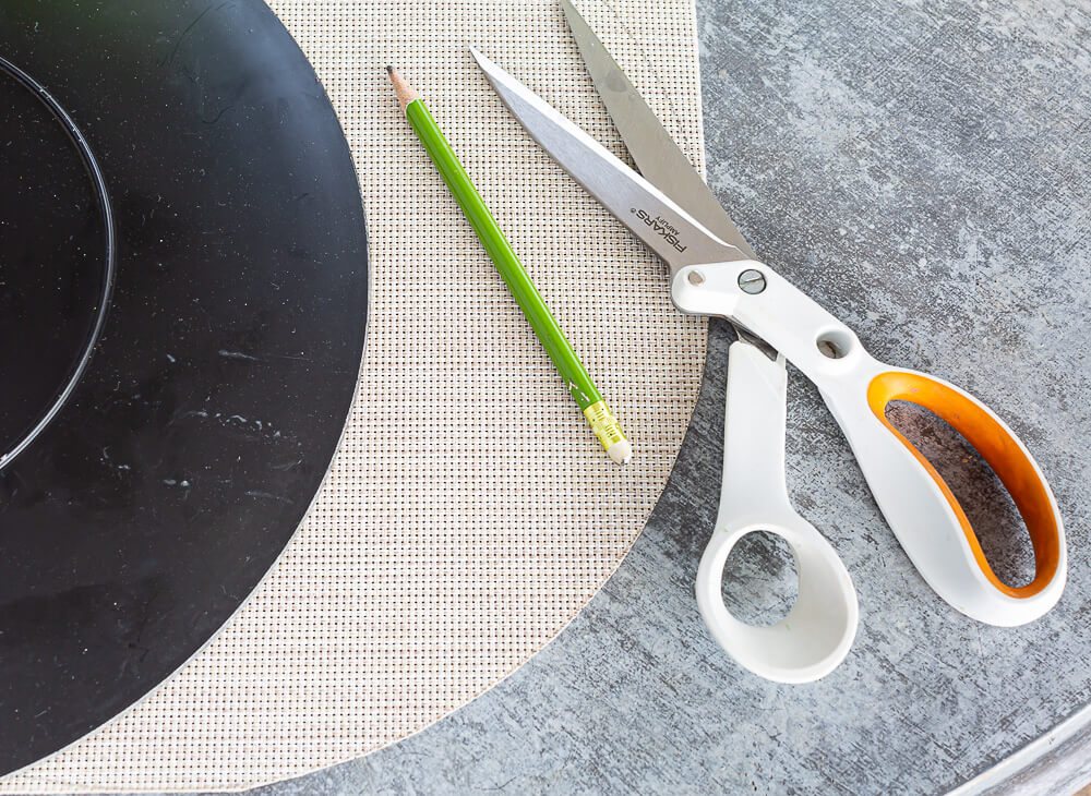 How to make a round template and cut a woven placemat to make it round.