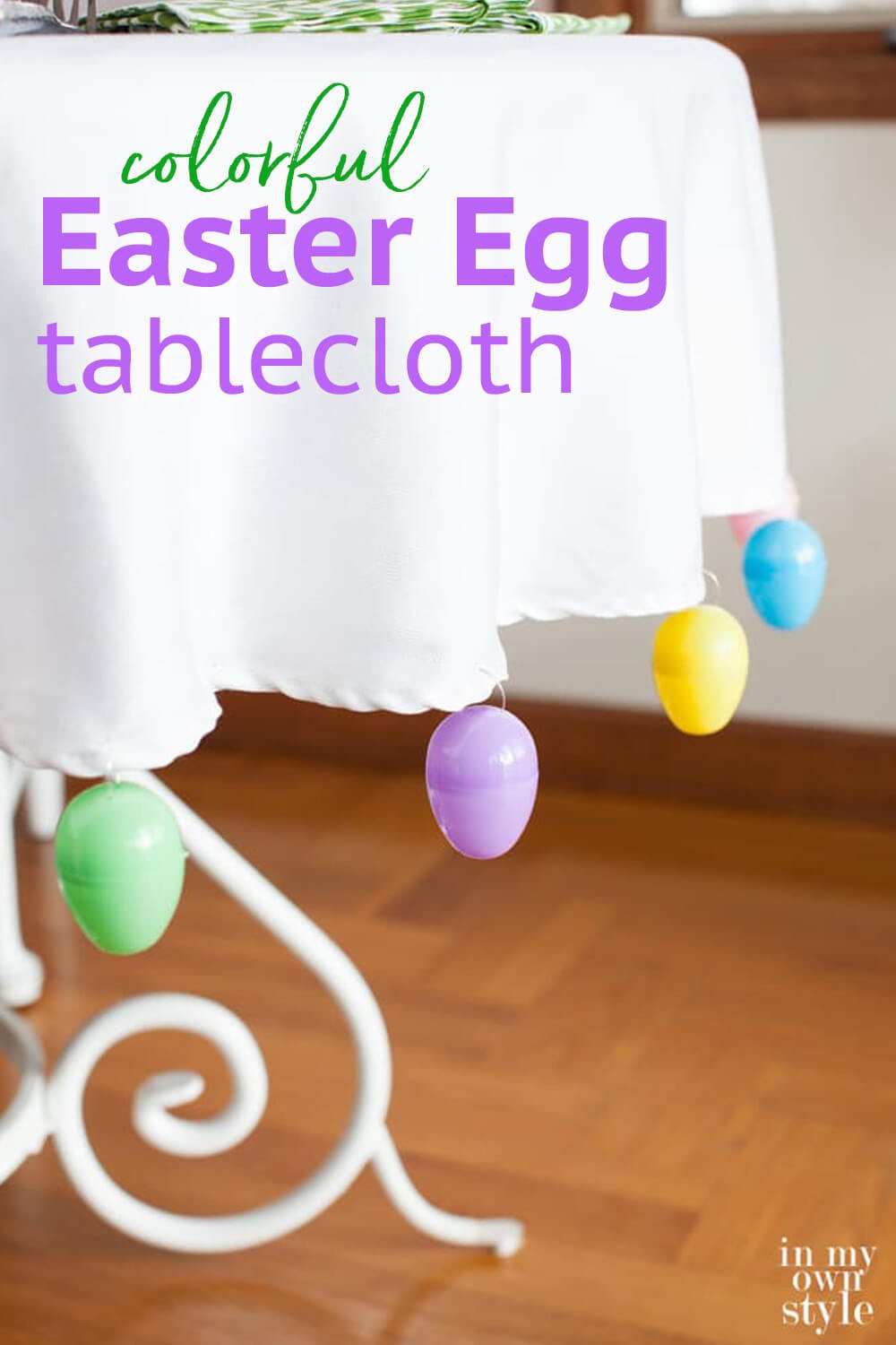 Easter decor table idea. Text overlay says colorful Easter egg tablecloth.