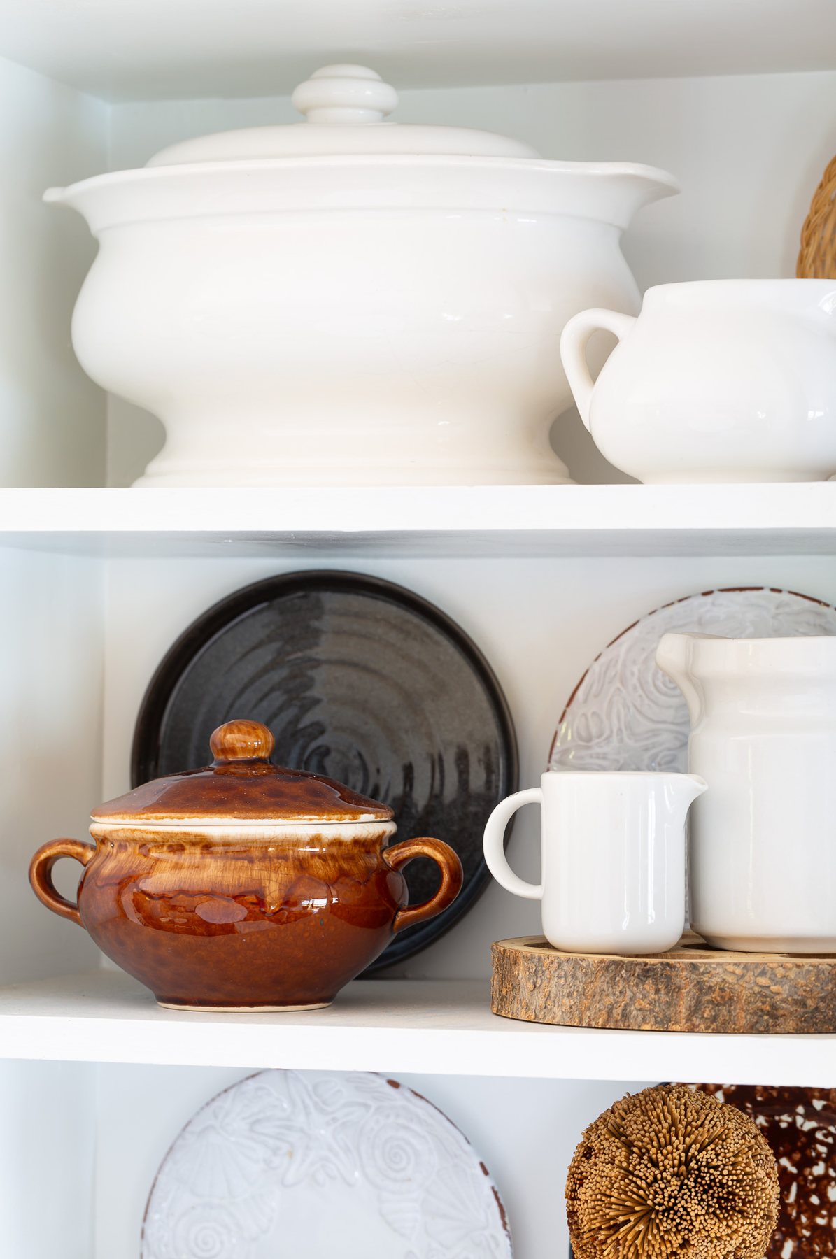 Fall kitchen decorating on open shelves using a brown and white color theme.