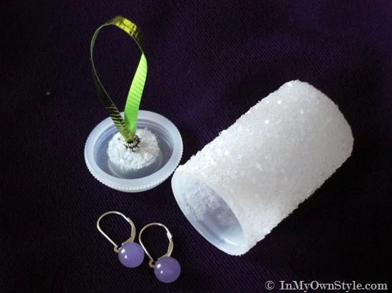 glittered covered film canister becomes a Christmas ornament when you attach ribbon to the top