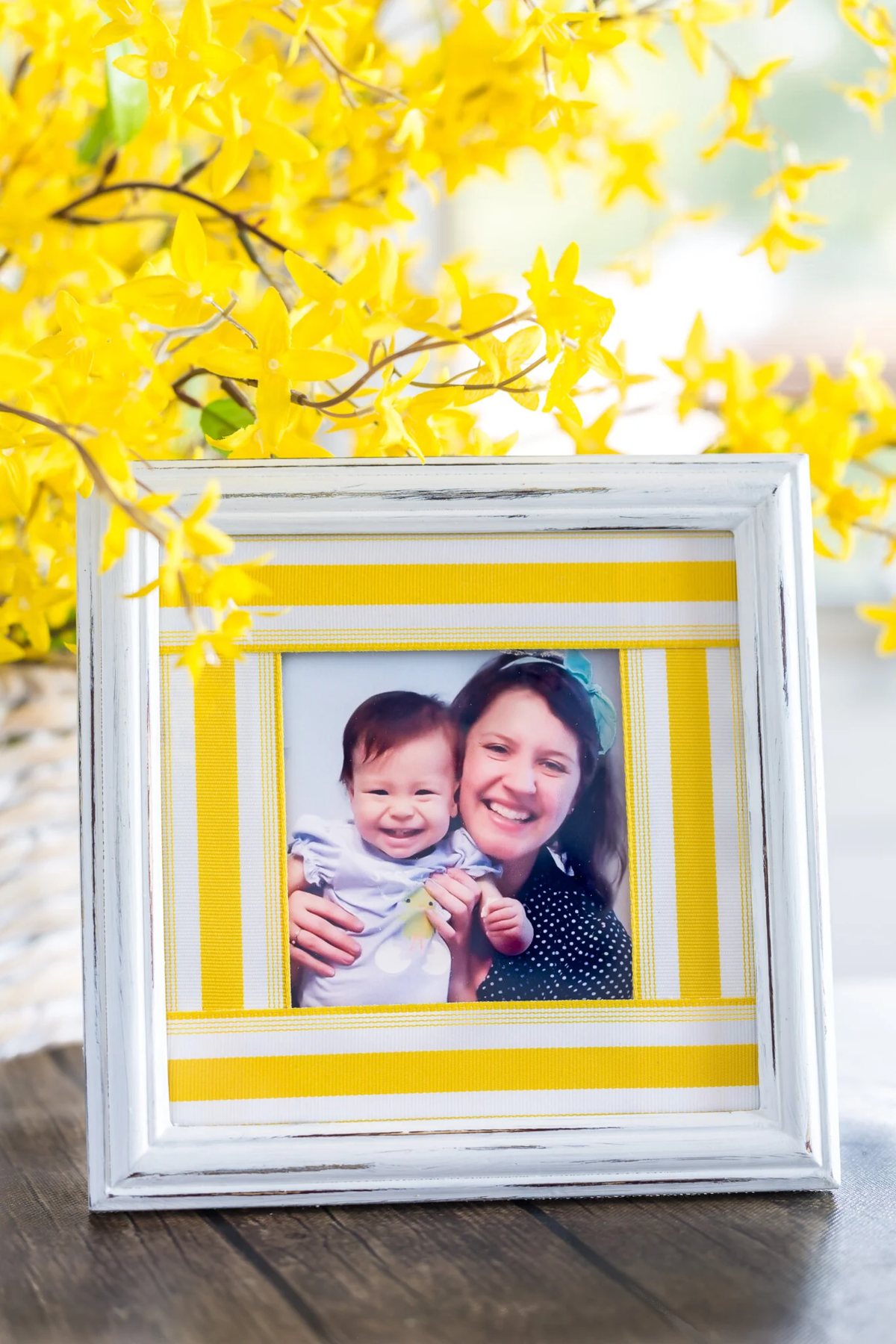 White picture frame with yellow stripe ribbon scrap picture frame mat. Two smiling girls.