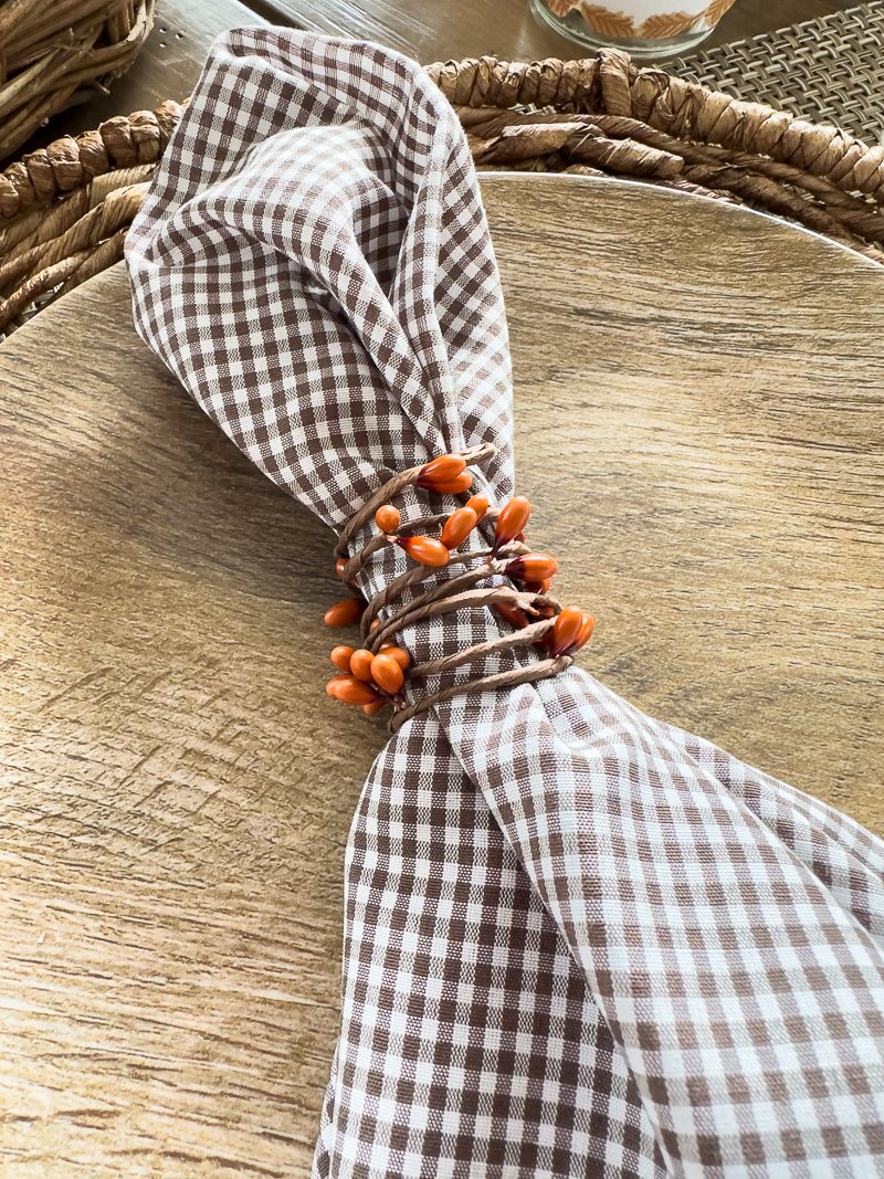 Fall colored Berry wire from Hobby Lobby used to make napkins rings for a Thanksgiving table place setting.