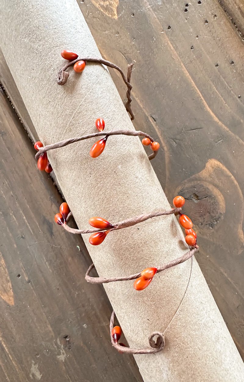 fall berries on wire wrapped around a cardboard tube to make a fall dinner napkin ring.
