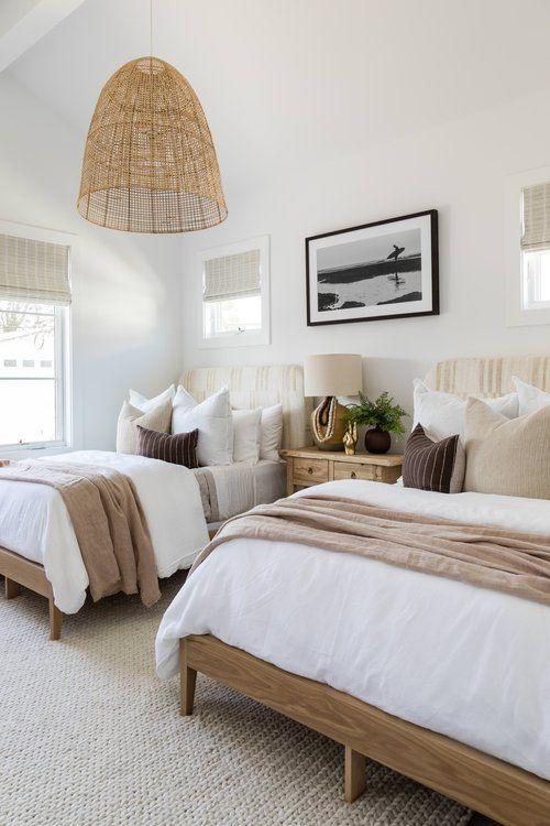 two queen size beds in a room that do not have bed skirts image by Pure Salt Farm
