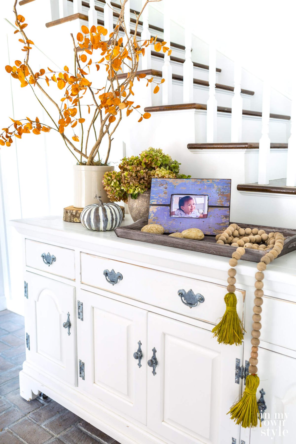 Fall decorating on a entryway sideboard.