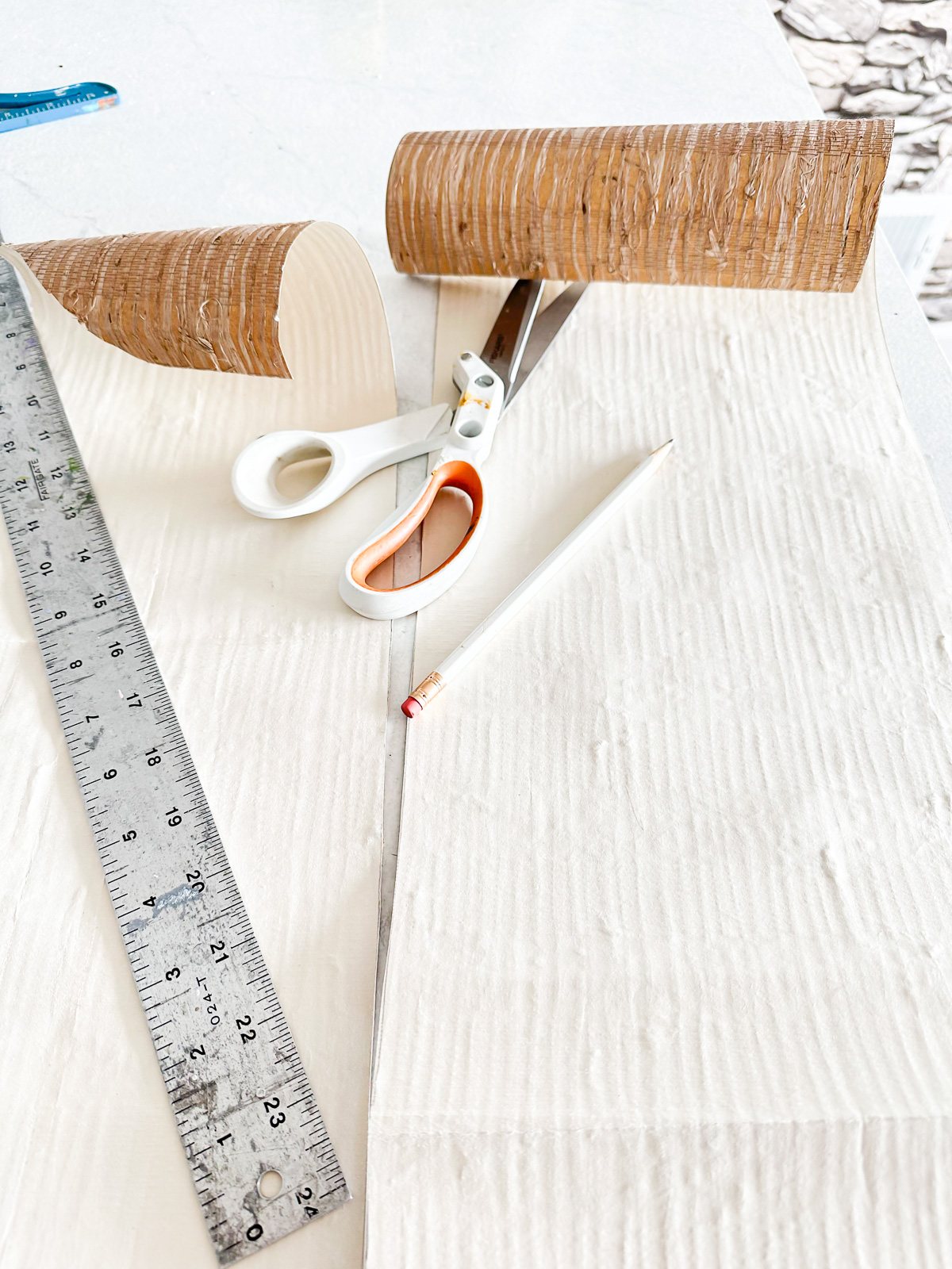 cutting wallpaper to fit to the shelf size in open kitchen shelves.