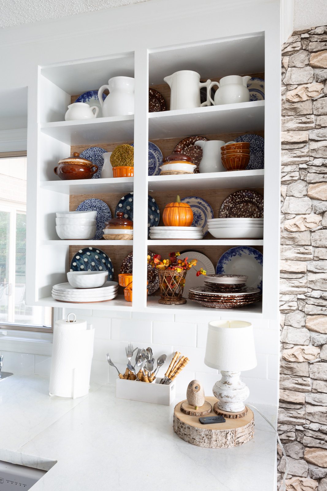 View of completed color and style changes of open kitchen shelves for fall.