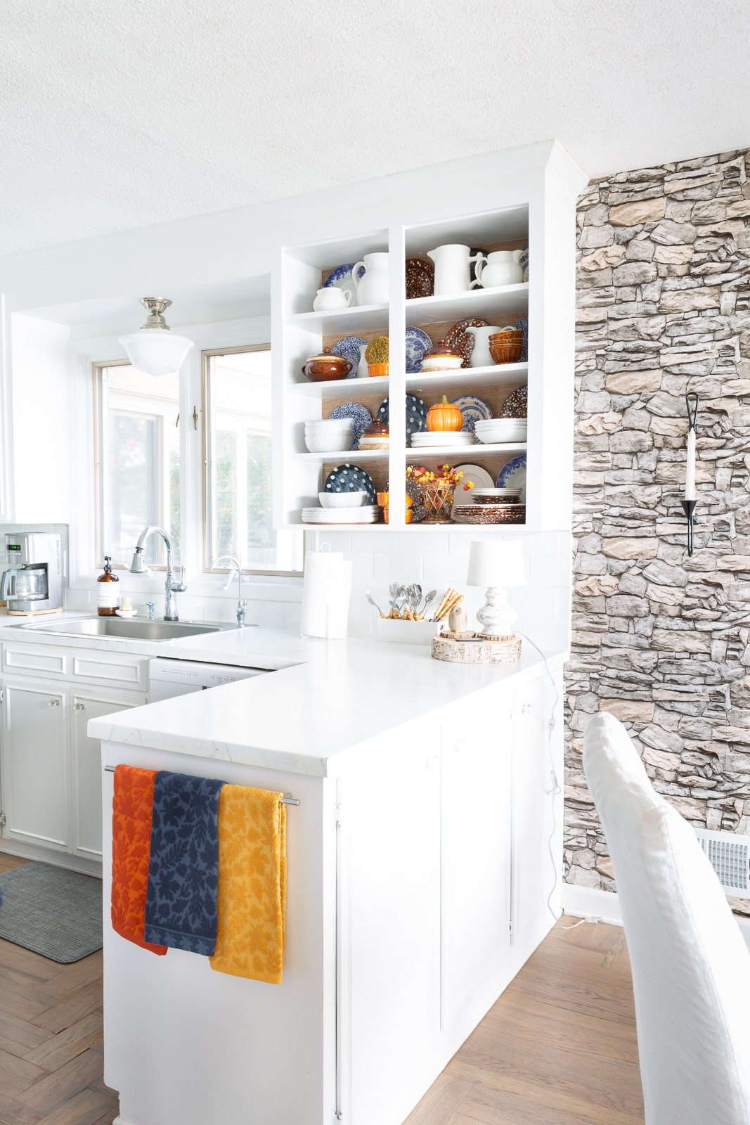 View of completed color and style changes of open kitchen shelves for fall.