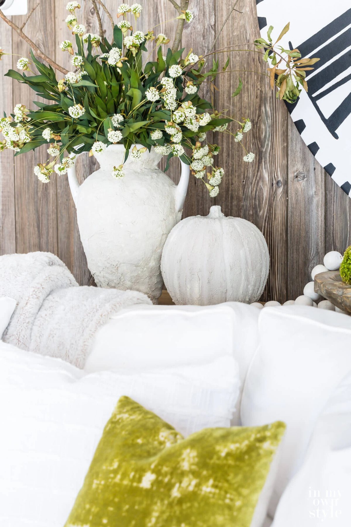 Plaster covered vase and pumpkin on sofa table.