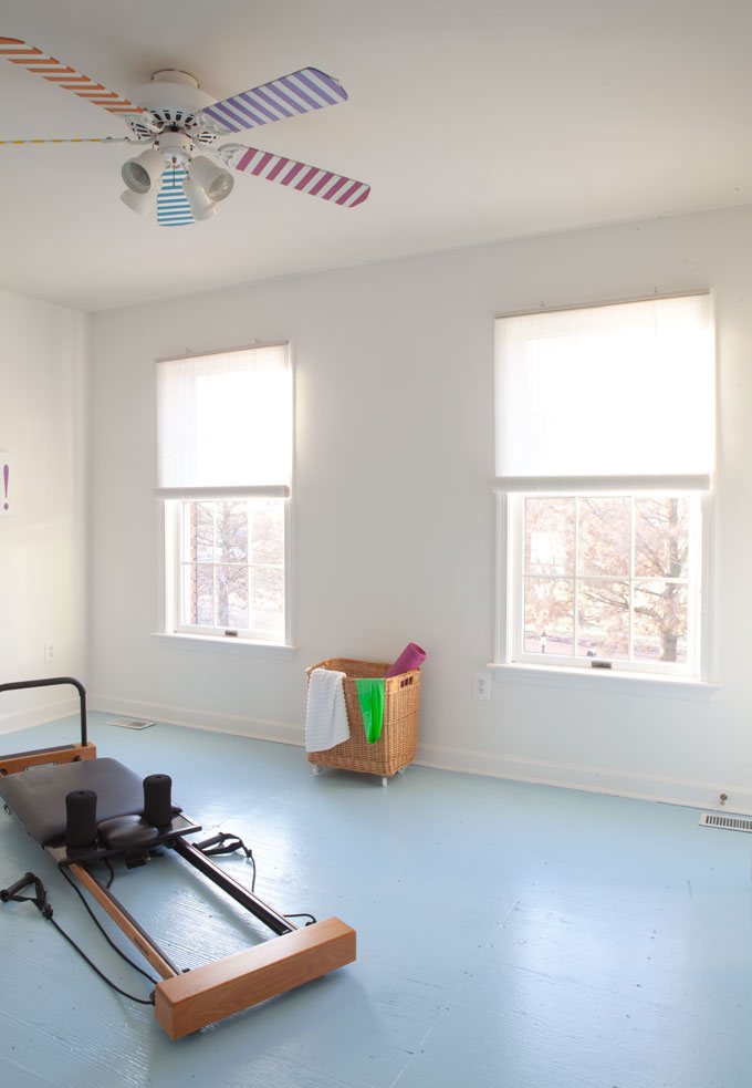 Affordable-Window-Blinds on two windows in a bedroom turned into a fitness room