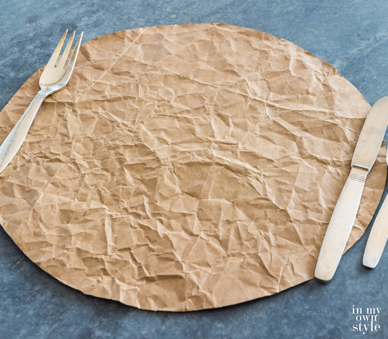 Brown bag cut into a circle and crinkled makes a rustic table placemat.