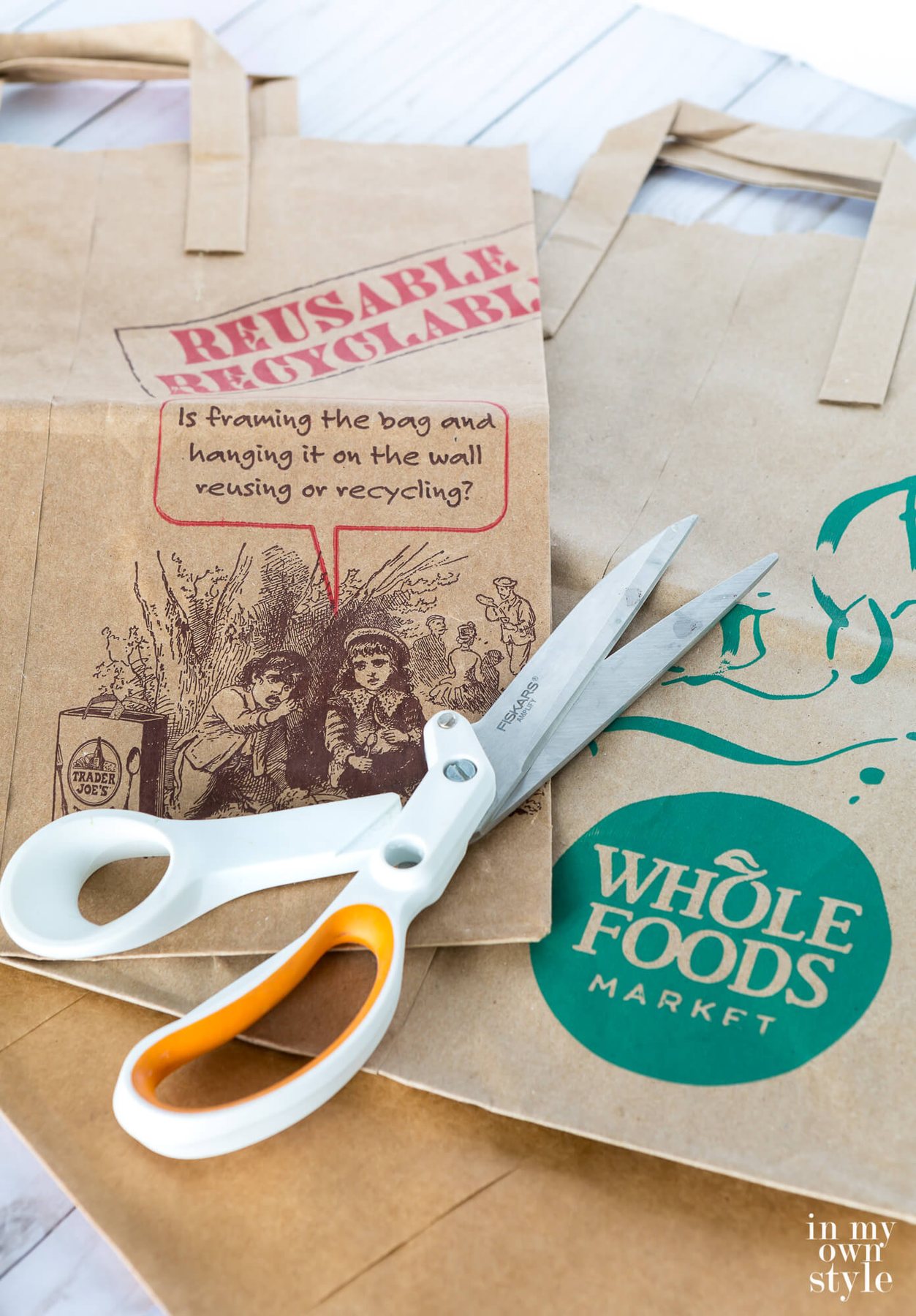 Two brown paper bags from Trader Joes and Whole Foods and a pair of scissors.