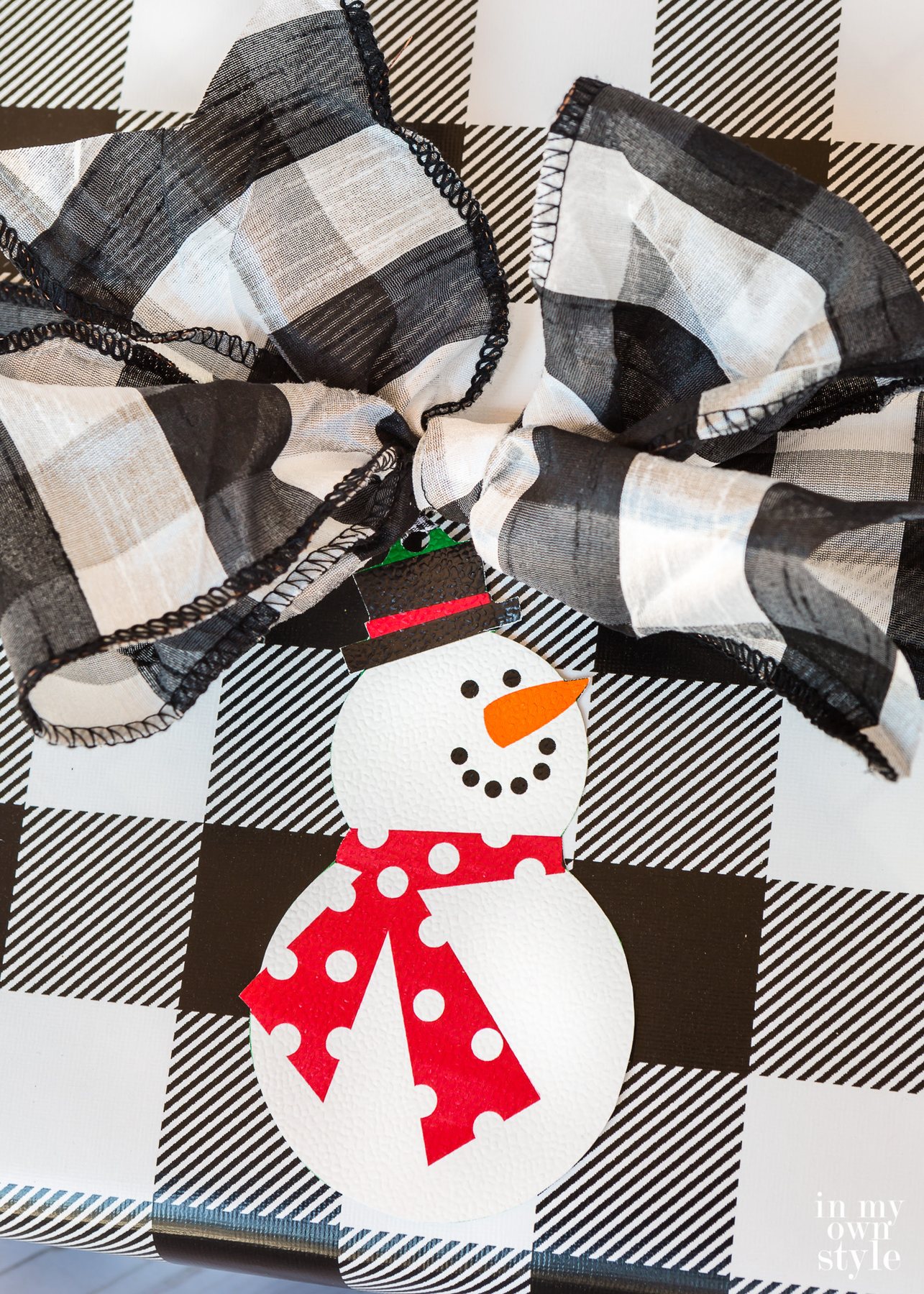 Christmas gift tag of a snowman made using wrapping paper