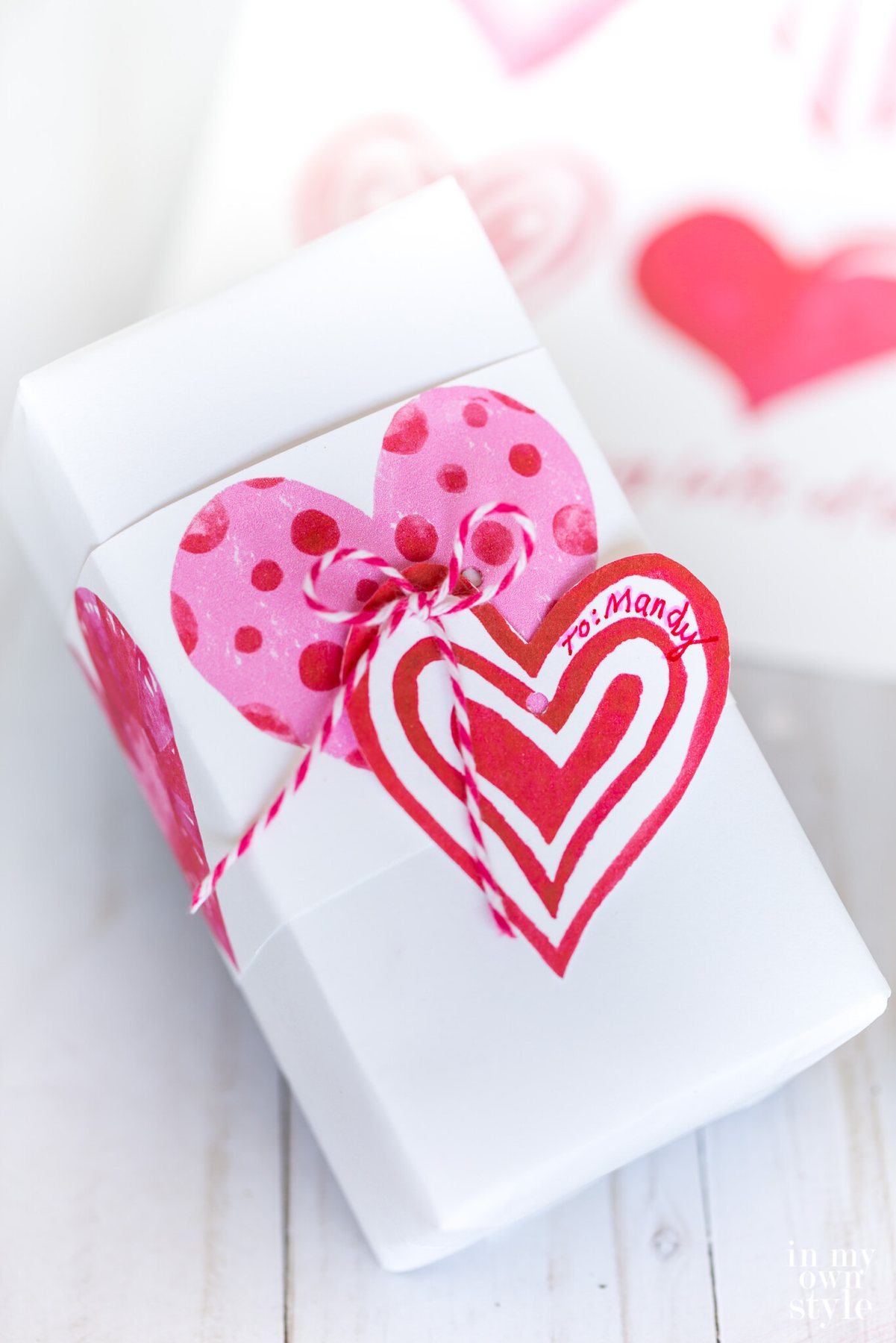 Valentine gift wrapping idea using a sheet of free printable watercolor hearts.