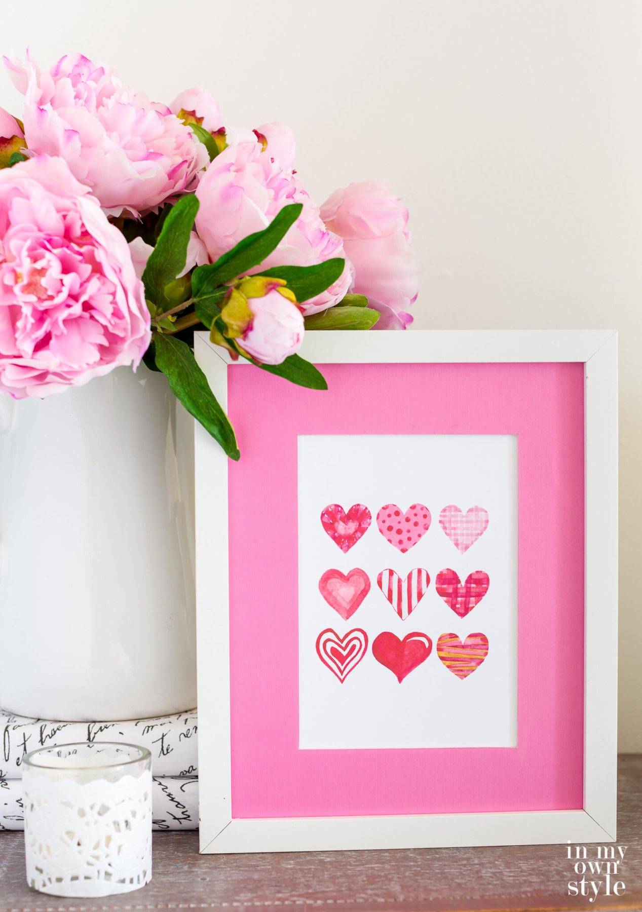 Free printable art of 9 Valentine hearts in a white frame.