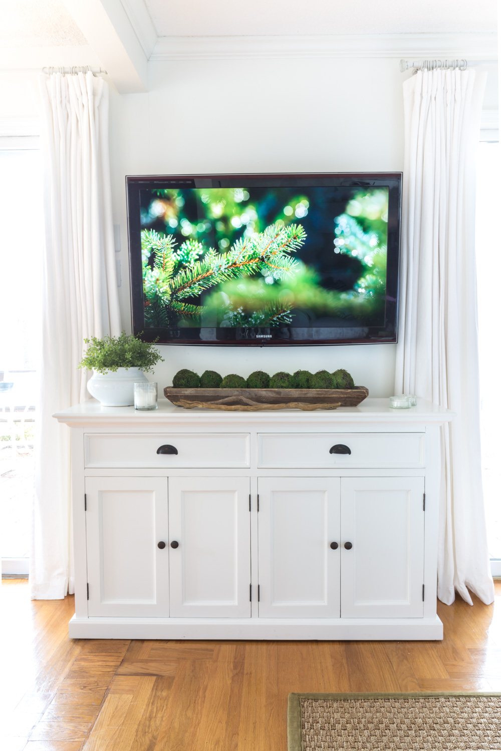 White furniture under wall mounted TV