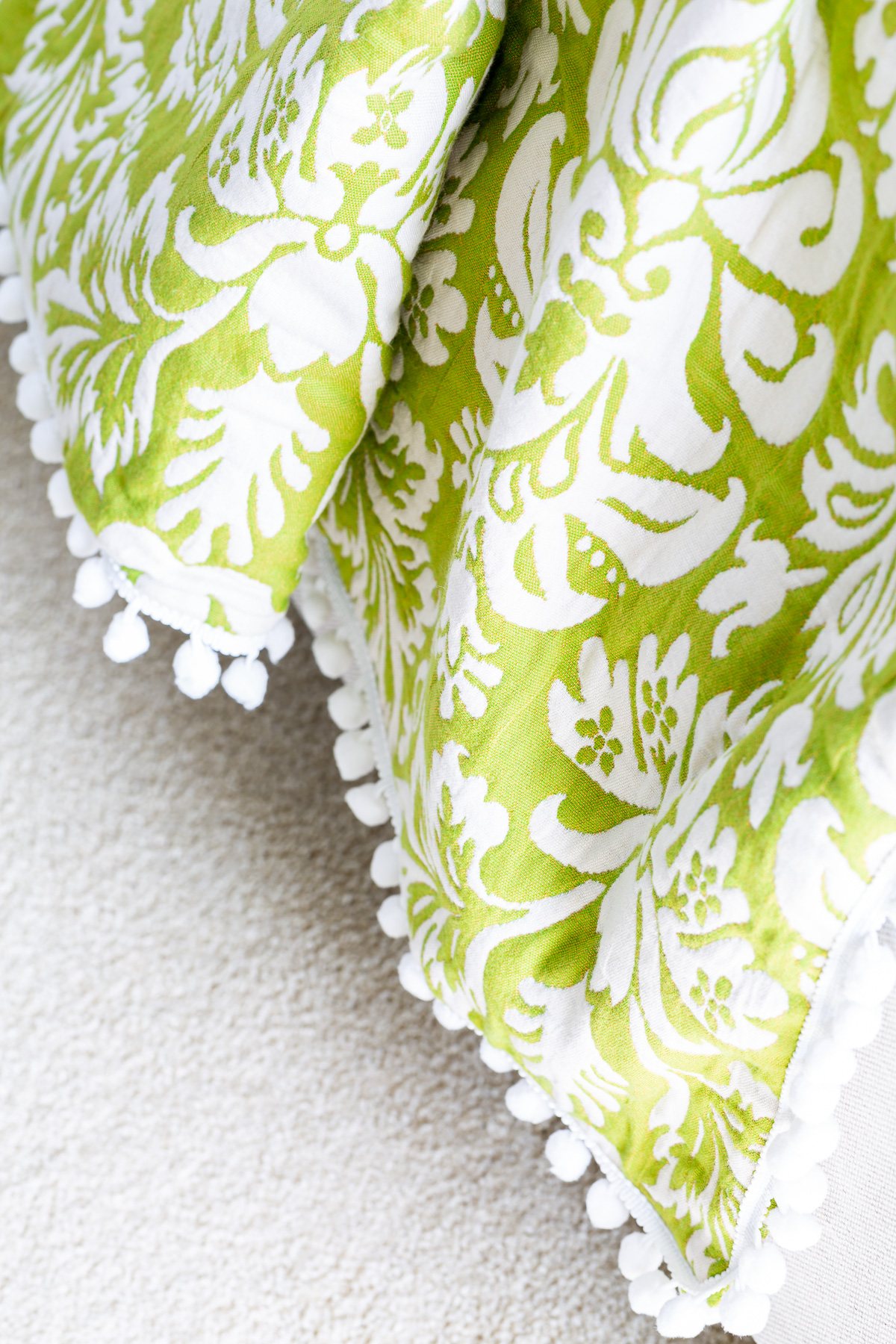 Close up of green and white large damask patterned DIY throw blanket.