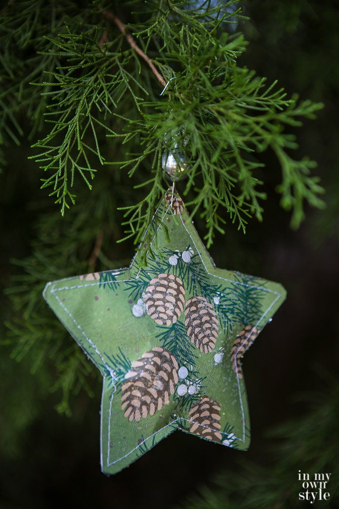 Christmas star paper ornament to make using scrapbook paper. It gets ripped open on Christmas morning to find a small gift inside.
