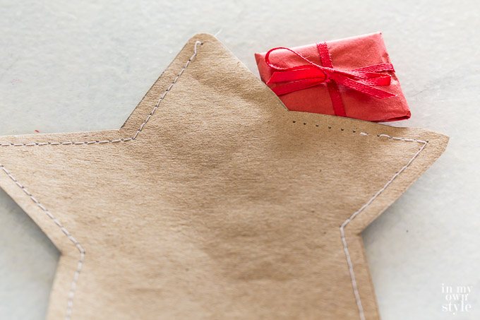 Placing surprise gift inside star before sewing closed.