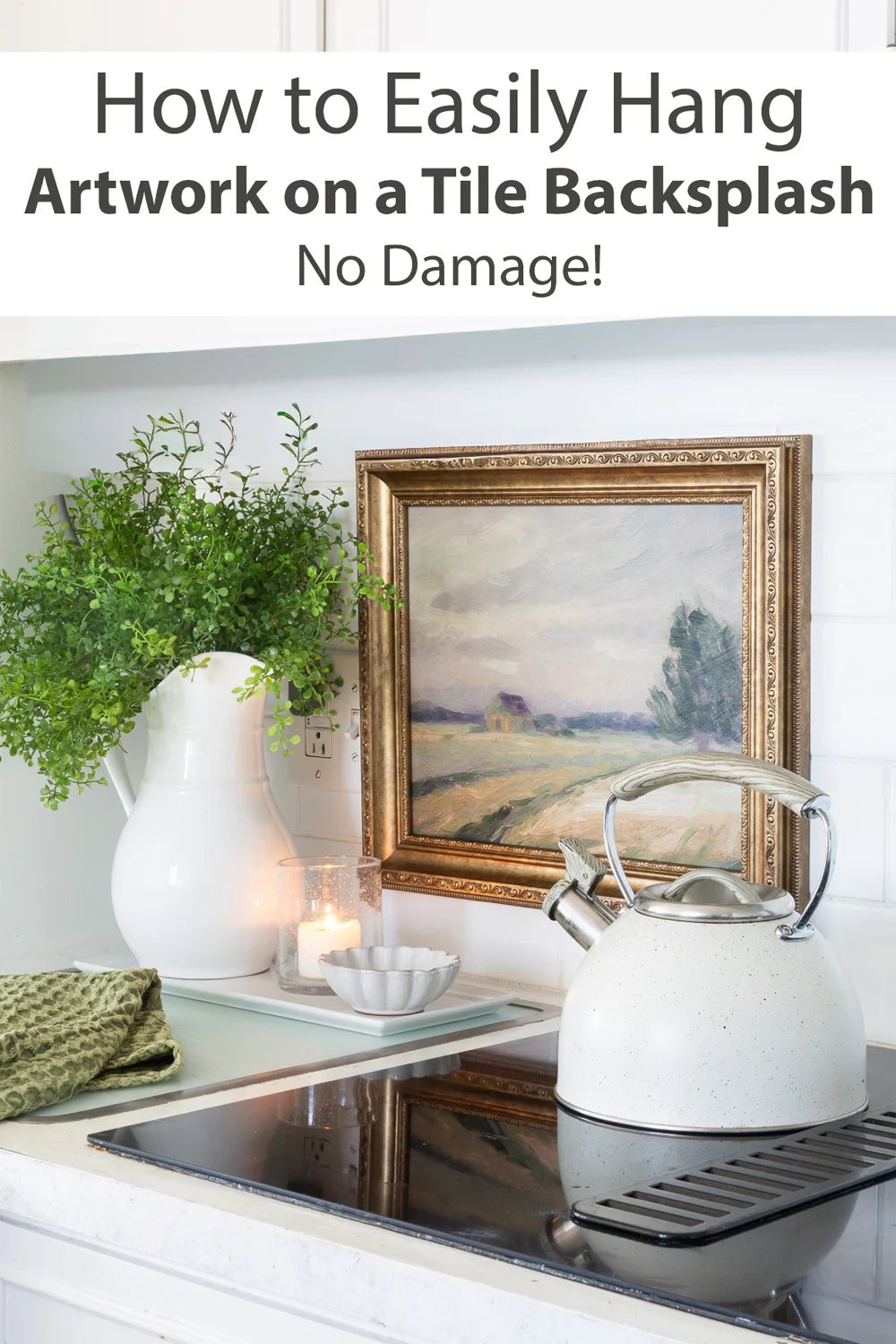 White kitchen showing how to hang art on a tile backsplash