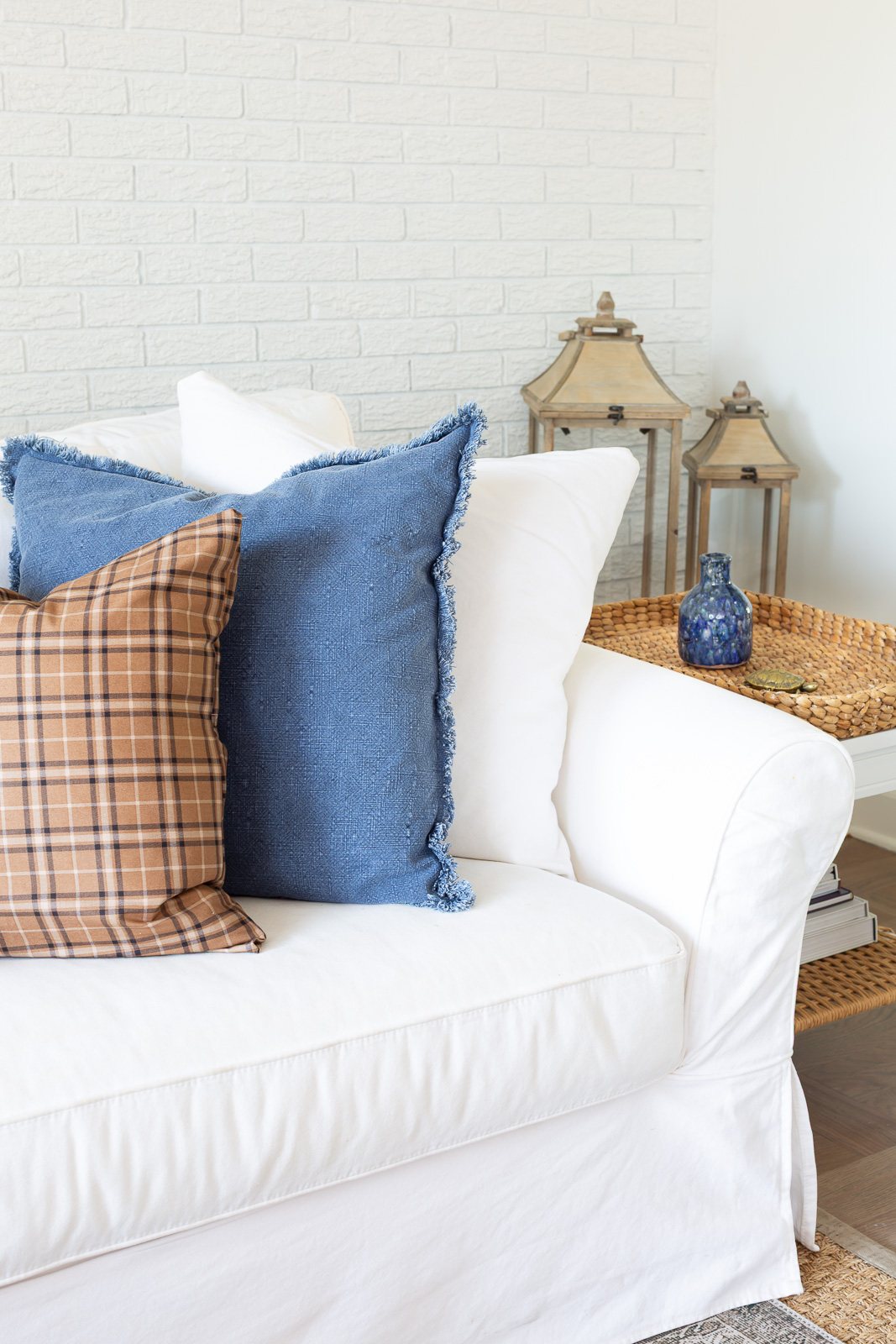 3 fall pillows lined up on a white sofa