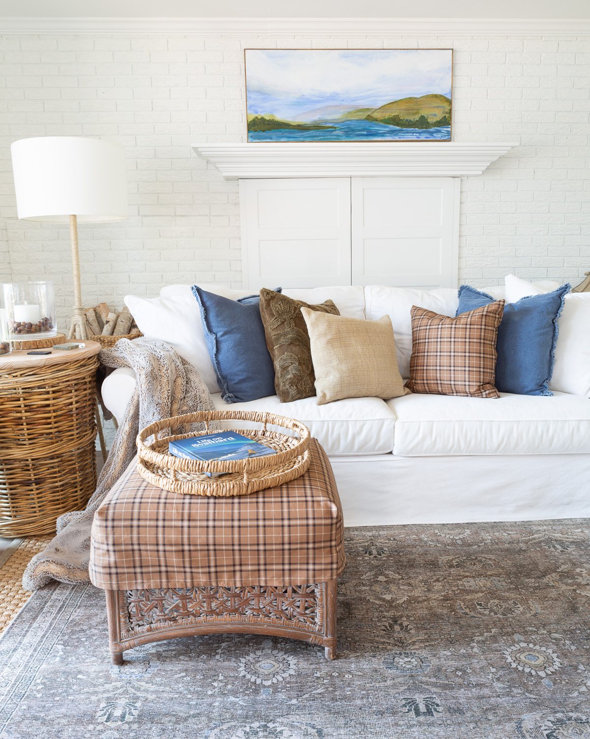 White blue and brown living room getting layers of fall decor started.