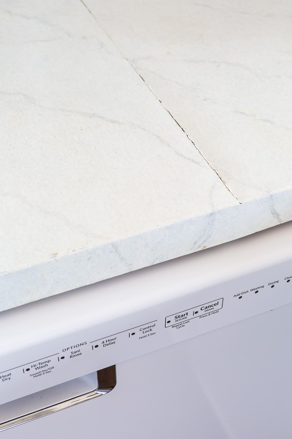 Seam in painted Formica is cracking since it gets heat from the dishwasher under it.